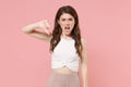 Dissatisfied shocked young brunette woman girl in light casual clothes posing isolated on pastel pink wall background Royalty Free Stock Photo