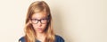 Dissatisfied teen girl looks suspiciously, sceptical, wearing glasses. Closeup portrait.