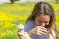 Dissatisfied unhappy teen girl eats tasteless ice cream in a waffle cone in summer. Selective focus