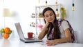 Dissatisfied woman looking at bills, shocked about expenses, planning budget