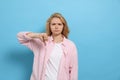 Dissatisfied young woman showing thumb down gesture on light blue background. Space for text Royalty Free Stock Photo