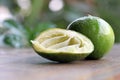 Dissect lime is squeeze out with full lime on the wooden table.