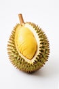 Dissected durian fruit with yellow pulp on table, white background