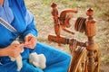 Distaff creates a thread from a spindle. Manual spinning wheel outdoors, lifestyle