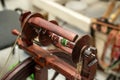 Distaff Day Wooden spinning wheel with yarn and hooks in workshop setting Royalty Free Stock Photo