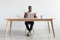 Handsome millennial black man working on laptop, making video call, having remote job, sitting at desk in home office Royalty Free Stock Photo