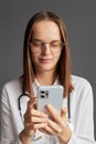 Distance healthcare support. Caucasian woman doctor wearing white medical lab coat stethoscope and glasses having remote