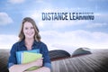 Distance learning against open book against sky Royalty Free Stock Photo