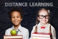 Distance learning concept with happy smiling children on blackboard background Royalty Free Stock Photo