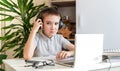 Distance learning online education. A schoolboy is studying at a computer at home and doing school homework. quarantine Royalty Free Stock Photo