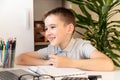 Distance learning online education. A schoolboy is studying at a computer at home and doing school homework. quarantine Royalty Free Stock Photo