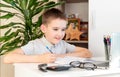 Distance learning online education. A schoolboy is studying at a computer at home and doing school homework. quarantine Royalty Free Stock Photo