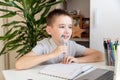 Distance learning online education. A schoolboy is studying at a computer at home and doing school homework. quarantine Royalty Free Stock Photo