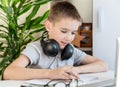 Distance learning online education. A schoolboy is studying at a computer at home and doing school homework. quarantine Royalty Free Stock Photo