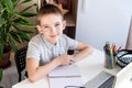 Distance learning online education. A schoolboy is studying at a computer at home and doing school homework. quarantine Royalty Free Stock Photo