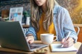 Distance learning online education and work. Business woman writes in notebook on desk. Happy and smiling girl working Royalty Free Stock Photo