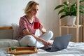 Distance learning online education and work.Happy woman girl working office work remotely from home on bed. Using Royalty Free Stock Photo