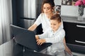 distance learning, online learning at home during the covid-19 pandemic. Family, mom and son doing homework in the room Royalty Free Stock Photo