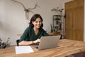 Smiling young woman entrepreneur work from home office using notebook Royalty Free Stock Photo
