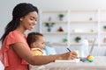 Distance Learning. Black Woman With Baby Study Online On Laptop At Home Royalty Free Stock Photo
