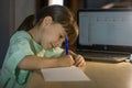 Distance online education. Little schoolgirl studies at home