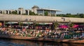 In the distance the Reichstag housing the Bundestag, Berlin Germany. People sitting by the River Spree in 2019 heatwave