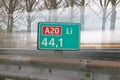 Distance sign in kilometers at motorway A20 at 44,1 kilometer on left side of the road, with speed lines of passings car. Royalty Free Stock Photo