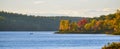 In the distance, two people in a boat. Late summer afternoon, sun shines golden light on a lake. Royalty Free Stock Photo