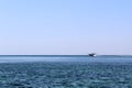 In the distance, a yacht rushes along the sea at high speed. Royalty Free Stock Photo