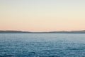 Distant blue adriatic sea with a tiny ferry ship far Royalty Free Stock Photo