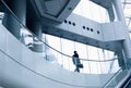 Distant businessman walking in a modern office building