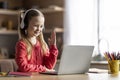 Distant Education. Cute Little Schoolgirl Study With Laptop At Home, Raising Hand During Online Lesson Royalty Free Stock Photo