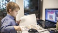 Distant education, online class meeting. Preschool boy studying during online lesson at home