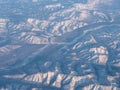 Distant frozen mountains seen from high n the sky Royalty Free Stock Photo