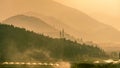 Distant hills behind fertile fields at sunset