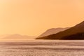 Distant hills in morning mist across the sea