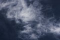 Jet plane and vapor trails going straight up across a cloudy deep blue sky. Royalty Free Stock Photo