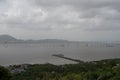 distant jetty extension of elefanta island down below from the mountain top with coastal water of arabian sea