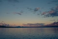 Distant kayaker paddling on calm Akkajaure lake