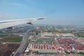 Distant landscape against blue sky under airplane wing