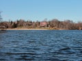 Distant Large House at Silent Blue Lake Royalty Free Stock Photo