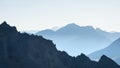 Distant mountain silhouette with clear sky and soft light. Toned image, vintage filter, split toning. Royalty Free Stock Photo