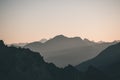 Distant mountain silhouette with clear sky and soft light. Toned image, vintage filter, split toning. Royalty Free Stock Photo