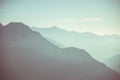 Distant mountain silhouette with clear sky and soft light. Toned image, vintage filter, split toning. Royalty Free Stock Photo
