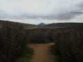 a distant mountain towering over a pass many miles away