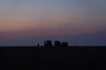 Distant shot of the silhouette of Stonehenge historical landmark at dawn Royalty Free Stock Photo