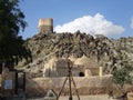 View of oldest mosque and a Portuguese Fort watch tower on hilltop in Fujairah, United Arab Emirates