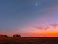 Stunning view of rocky sunset beach with moon rising over the Pacific Ocean Royalty Free Stock Photo