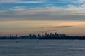 Distant silhouette of Sydney cityscape at dusk, on sunset Royalty Free Stock Photo