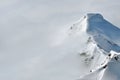 Distant snow covered peaks above clouds Royalty Free Stock Photo